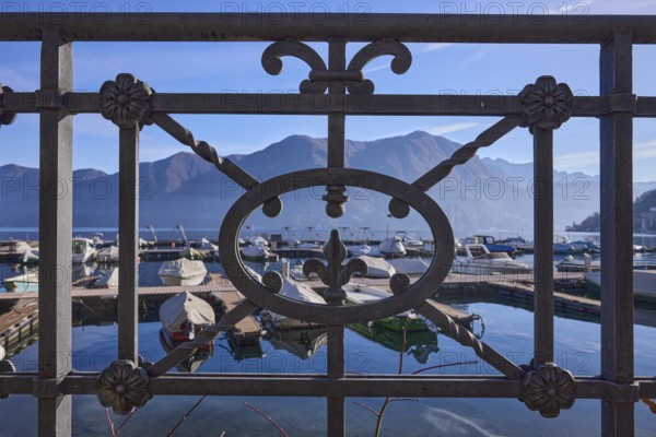 Forged railing, close-up, backlight, lake, mountains, haze, marina, depth of field, Lake Lugano,