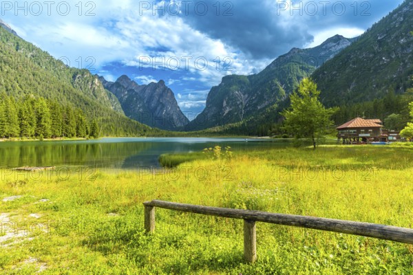 Stunning landscape showing the reflections of the dolomites mountains on the calm waters of lake