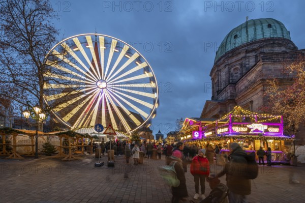 The winter village with Ferris wheel, Christmas market on Jakobsplatz to the right of St