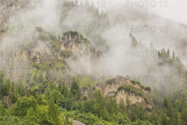 Wisps of mist cover the Karwendel mountains in the Großer Ahornboden nature reserve, Eng Valley,