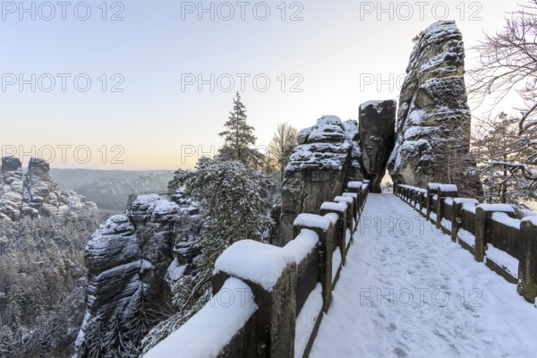 Snow on the Bastei bridge, rock gate and rock castle Neurathen in the morning, Saxon Switzerland,