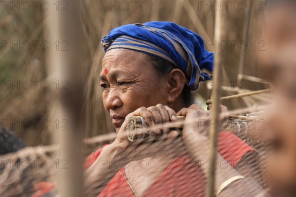 Villagers participate in a community fishing event on the occasion of the Bhogali Bihu festival at