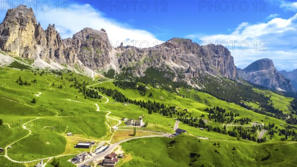 Breathtaking aerial view of the scenic gardena pass in the dolomites, showcasing winding roads,