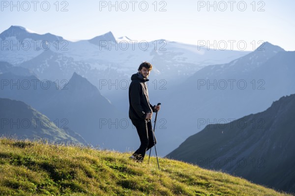 Hiker enjoying the mountain panorama in the morning, Venediger group, behind Dreiherrenkopf,