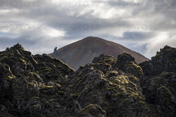 Lava field in front of colourful rhyolite mountain Brennisteinsalda, volcanic landscape, erosion