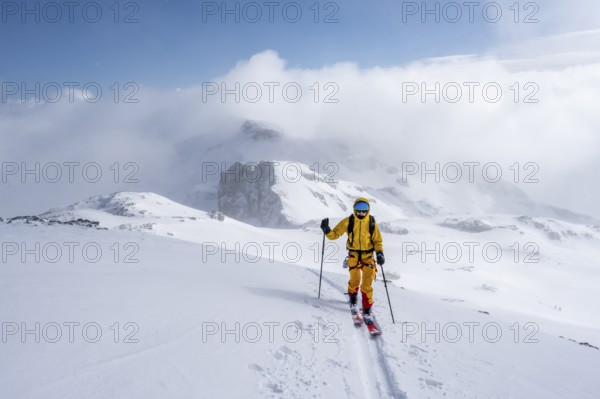 Ski tourers in a snowy mountain landscape, ascent to the Wildhorn, cloudy mood, high tour, Bernese