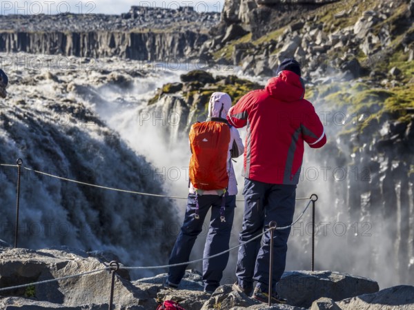 Tourist at viewpoint close to waterfall Dettifoss, east side, Iceland, Europe