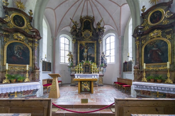 Parish church of St Sebastian with richly decorated altar, statues of saints and paintings, framed