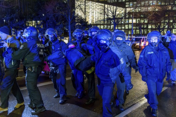Police clear the protests in front of the Axel Springer skyscraper against the World Economic