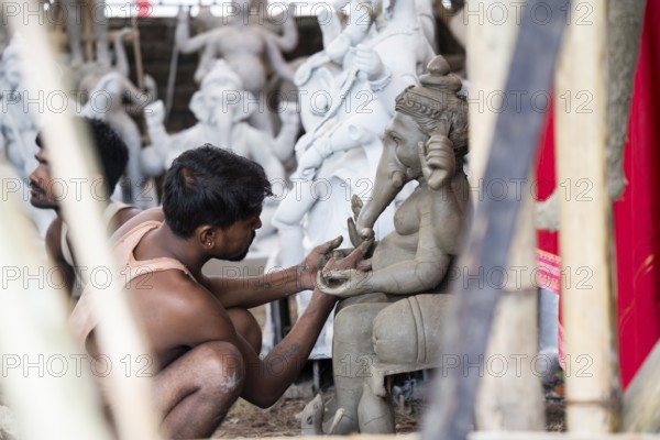 Artisan work on idols of the elephant-headed Hindu deity Ganesha at a workshop ahead of the Ganesh