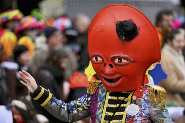 Person dressed up as a red mascot at the Wey guild on Rose Monday, Güdismäntig, Lucerne Carnival