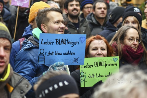 Heidelberg, Germany - February 12th 2025: Person holding up sign saying 'I'd rather wear blue than
