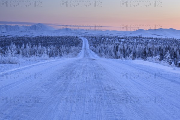 Snow-covered gravel road, highway, ice, snow, cold, mountain landscape, winter, morning mood,