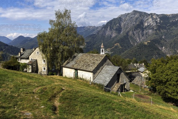 View of the village, typical Ticino stone houses in the mountain village of Rasa, Centovalli,
