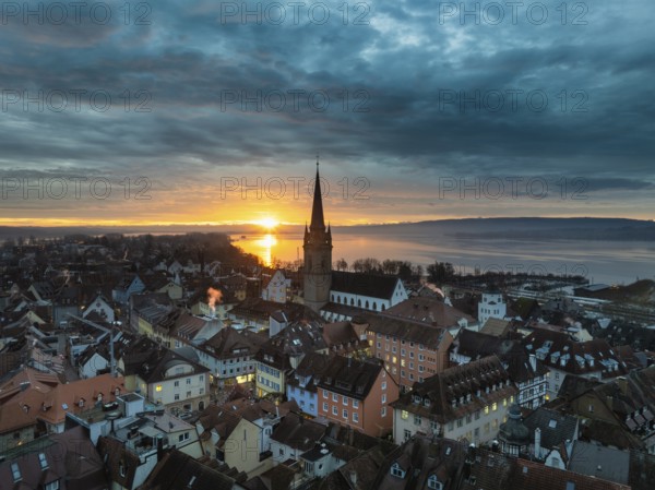 Aerial view of an atmospheric sunrise over the town of Radolfzell on Lake Constance with the