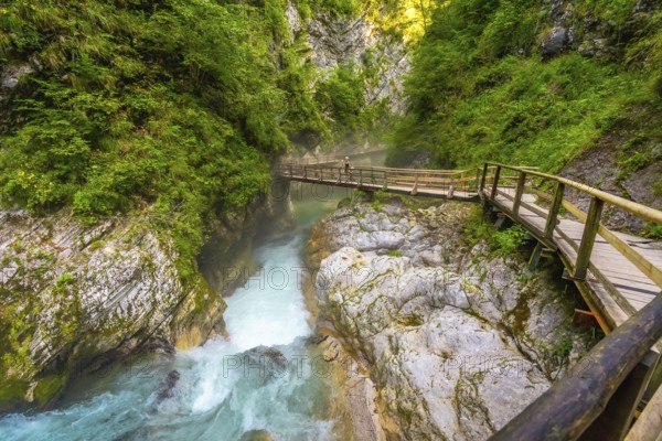 Wooden tourist pathway over the radovna river flowing through the vintgar gorge near bled in