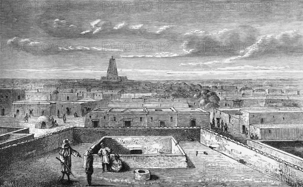 City view of the oasis city of Timbuktu in the 19th century, flat mud houses, tower of a mosque,