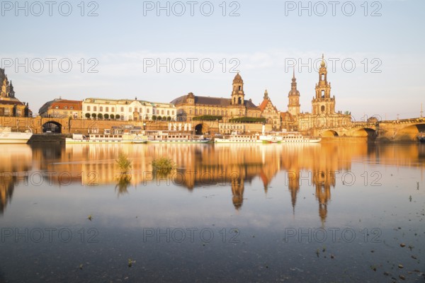 Silhouette of the Old Town with reflection in the Elbe in the morning, steamboats on the