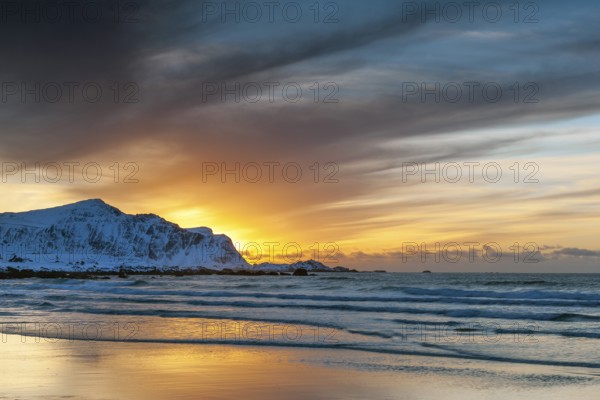 Sunset in winter at Skagsanden, stones on the beach at Flakstad, Flakstadøy, Lofoten, Nordland,