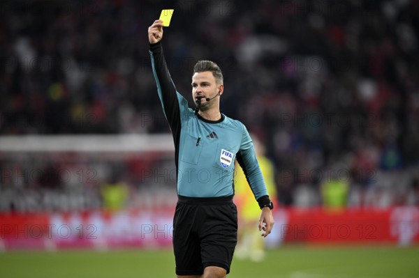 Referee Referee Daniel Schlager shows yellow card yellow caution Allianz Arena, Munich, Bavaria,