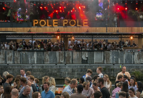 Spectators on grandstand at the Graslei watching Pole Pole podium during Gentse Feesten, Ghent city