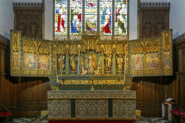 Elaborately carved gilt altar reredos screen 1938, church of Saint John the Baptist, Peterborough,