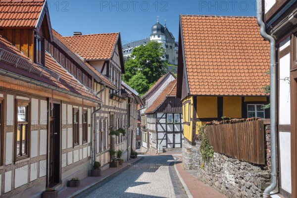 Street with half-timbered houses and cobblestones in the historic old town, behind the castle,
