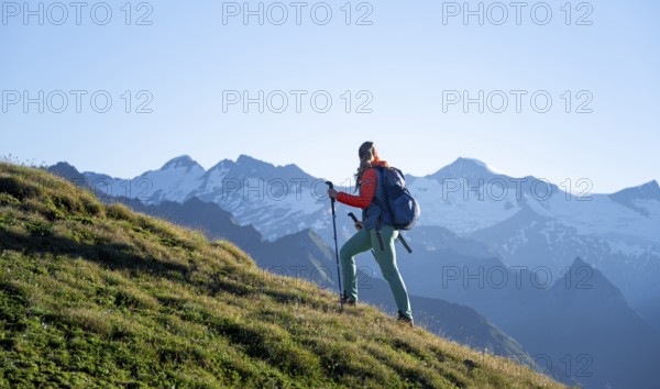 Hiker enjoying the mountain panorama in the morning, Venediger group, behind Dreiherrenkopf,