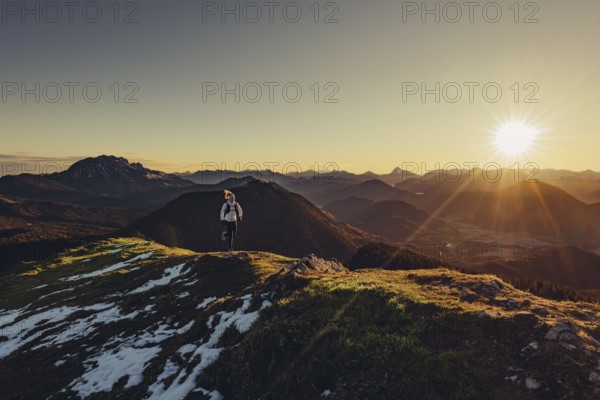 Trail running in autumn on the Jochberg on Lake Walchensee against the wonderful backdrop of the
