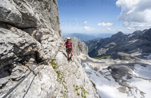 Mountaineer with helmet in a secured via ferrata, Zugspitz via ferrata, ascent to the Zugspitze,