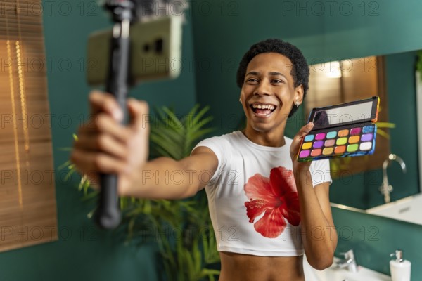 Lgtb man latin vlogger recording make up tutorial at home
