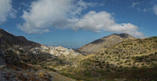 A vast landscape with mountains and the picturesque village of Olymbos in the valley under a clear