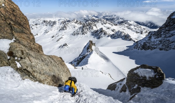 Mountaineer with ice axe and crampons, ascent through steep snowfield to Piz Kesch or Piz d'Es-cha