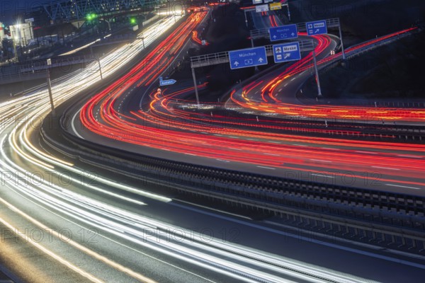 A8 motorway at Stuttgart Airport in the evening. Heavy traffic, lanes of light. Modern architecture