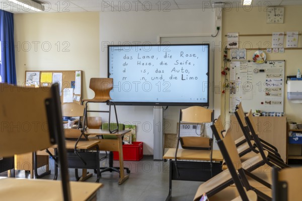 Classroom of a fourth grade, after school, the building is older but in good condition, modern