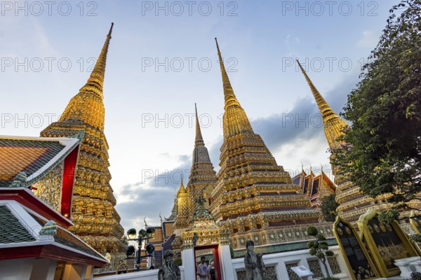 Wat Pho temple at sunset. Bangkok's oldest Buddhist monastery near the Grand Palace. Four chedis