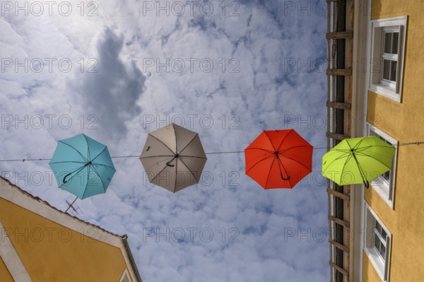 Colourful umbrellas stretched across the street, promising a prosperous and perfect life,