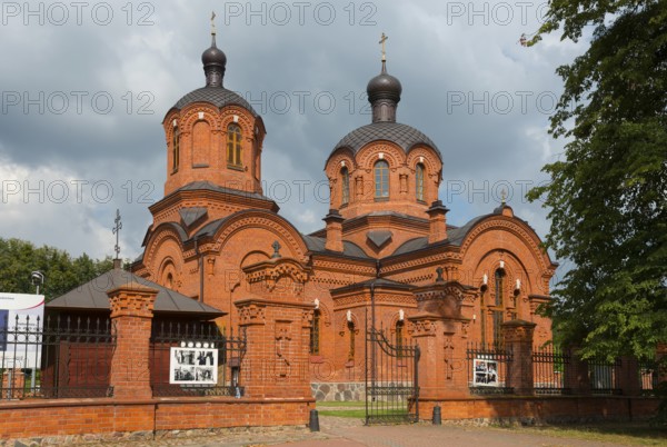 Orthodox church with two red-brick domes, enveloped in dramatic clouds, Orthodox Church of St