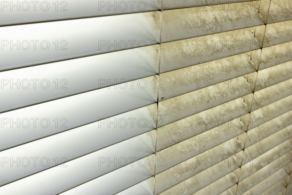 Residential window shades showing the before and after of a good cleaning, one side clean and one