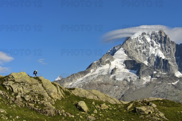 Hikers in the Aiguilles Rouges nature reserve against the impressive backdrop of the summit of the