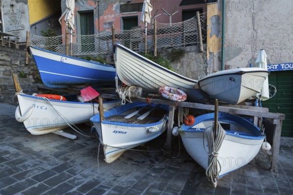 Close-up of stored white and blue traditional fishing boats on dry land, Riomaggiore, Cinque Terre,