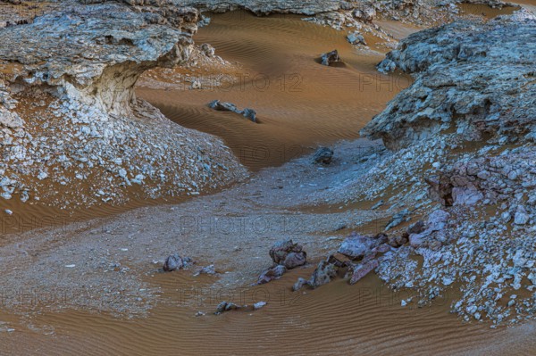 Striking cliffs surrounded by windswept sand structures, Huqf stone desert, Arabian Peninsula,