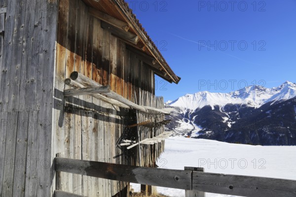 The Serfaus, Fiss, Ladis ski area in winter. In the foreground a wooden hut typical of the