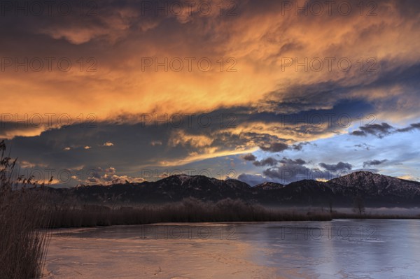 Dawn, clouds over a lake in front of mountains, winter, Riegsee, near Murnau, Bavaria, Germany,