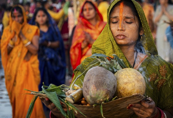 Hindu devotees perform rituals as they offer prayers to the Sun god in the bank of Brahmaputra