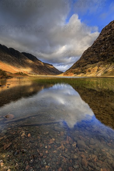 Mountains reflected in lake, evening light, cloudy mood, autumn, Loch Achtriochtan, Glencoe,