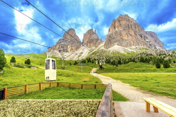 Cable car ascending to the sassolungo group, with its majestic peaks, located in the italian