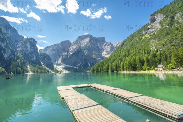 Breathtaking landscape with emerald green water and majestic peaks in the italian dolomites,