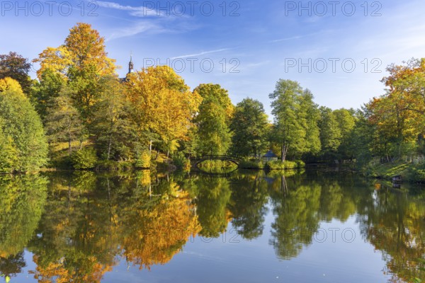 Castle pond with bridge and Pfaffroda Castle in autumn, Olbernhau, Erzgebirge, Saxony, Germany,