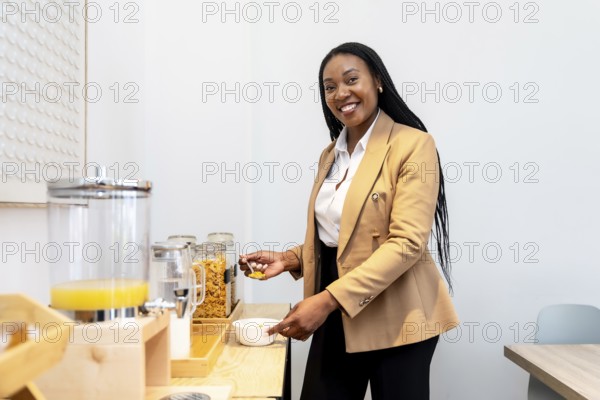 Businesswoman serving herself some cereal at the hotel breakfast buffet during her business trip,